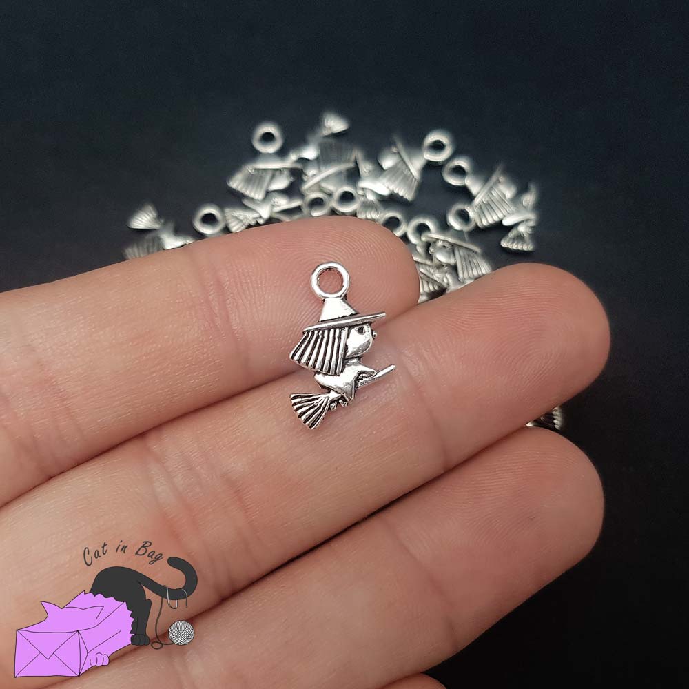 10 charms with witch on broom, silver tone