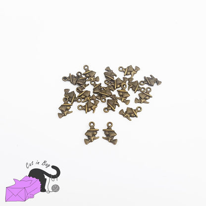 10 charms with witch on broom, antique bronze tone