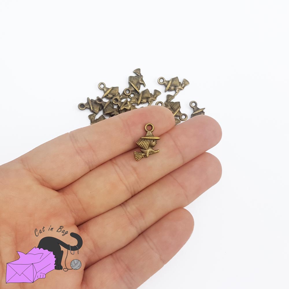 10 charms with witch on broom, antique bronze tone