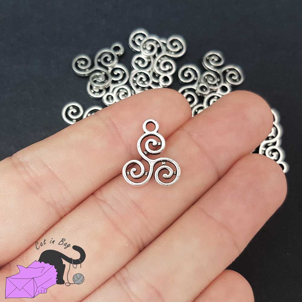 10 charms with Triskel silver tone