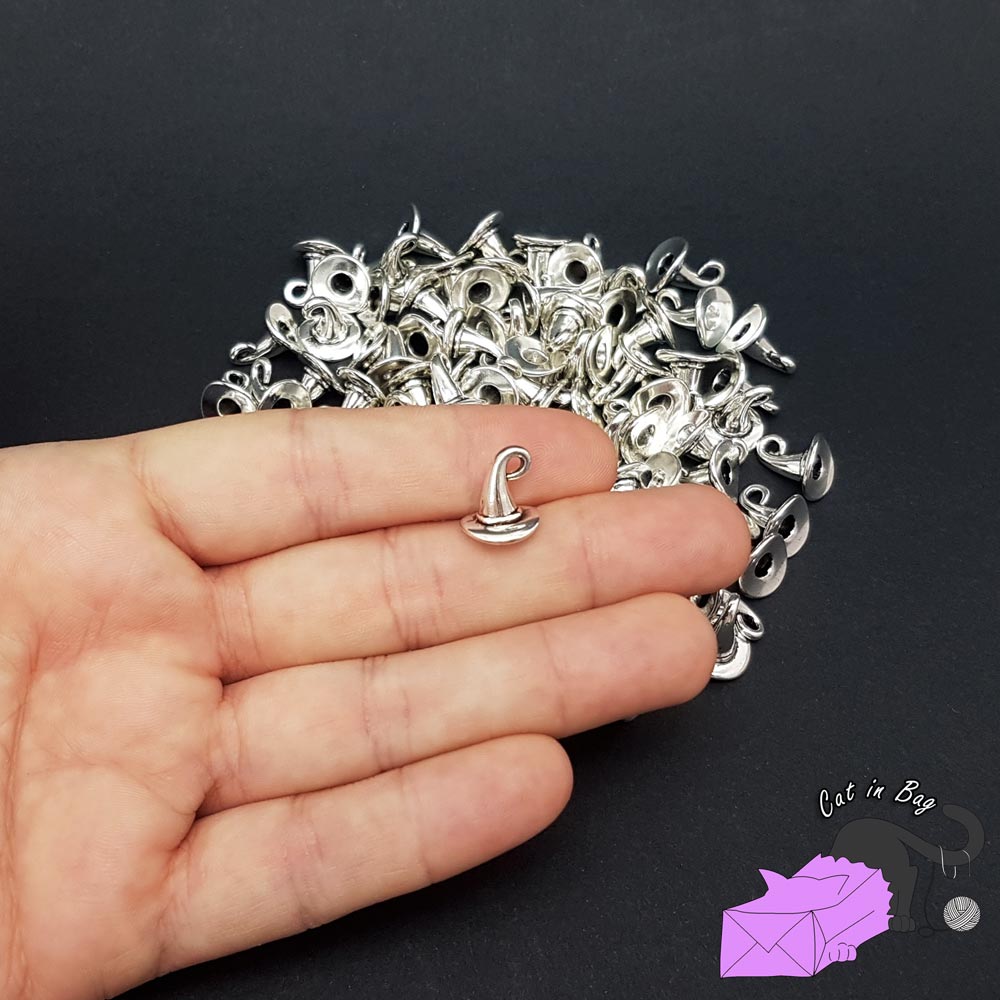 10 charms with silver tone witch's hat