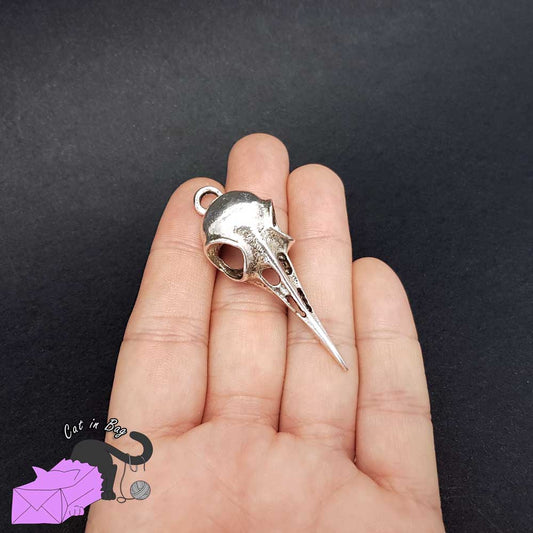 2 charms with crow skull