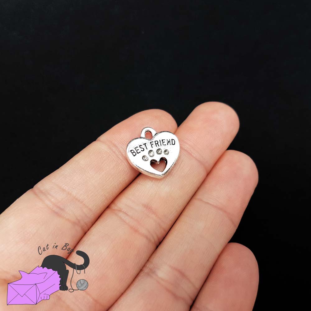 5 heart charms with paw and the words "best friend"