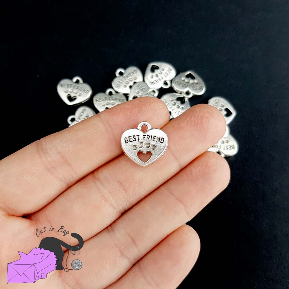 5 heart charms with paw and the words "best friend"