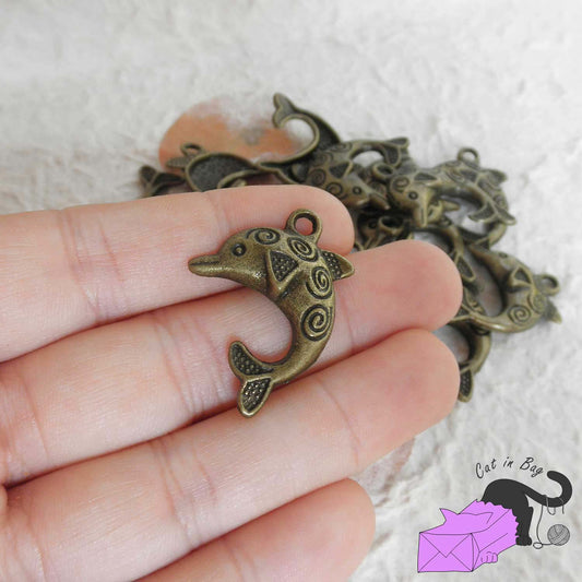 5 charms with dolphin and spirals